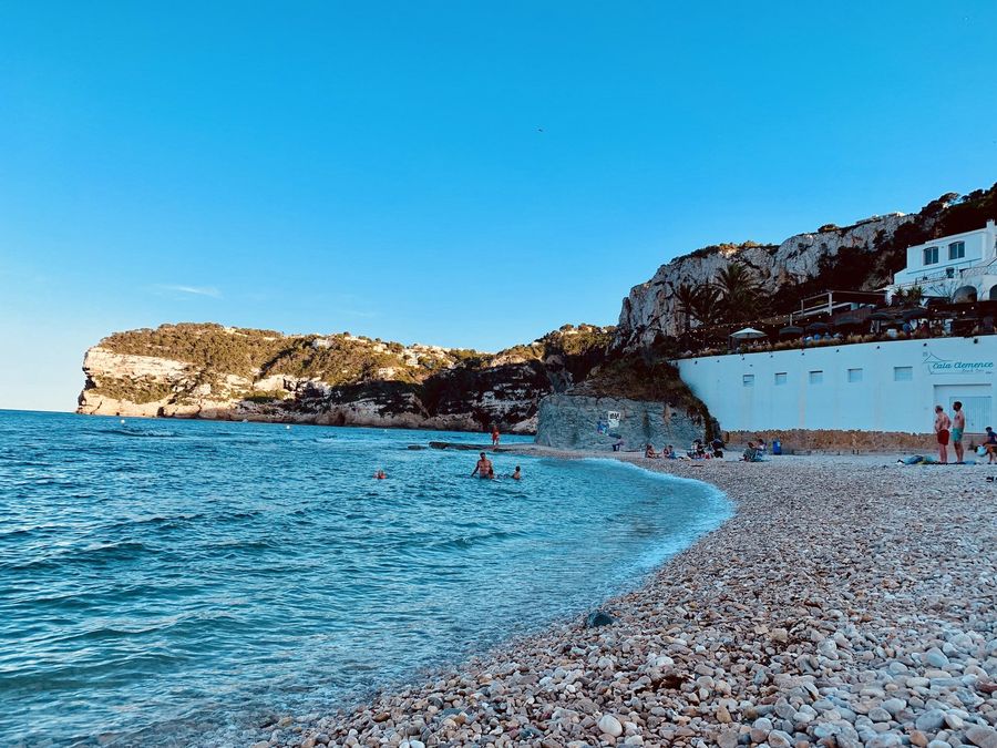 La plage de galets avec Cala Clemence au-dessus de l'eau